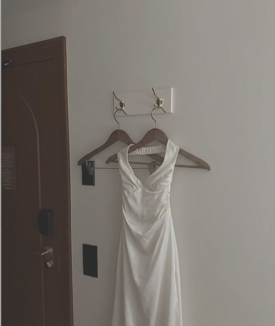 White satin dress hanging by the door