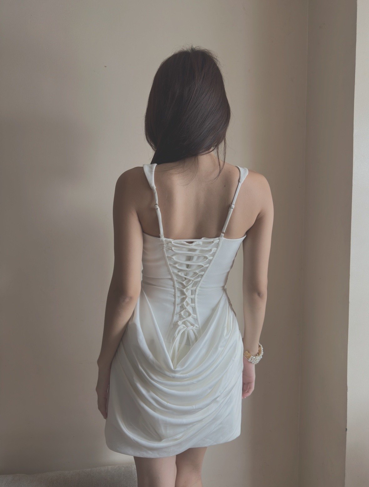 Back detail of a white lace-up dress